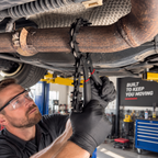 Chain-style exhaust cutter in use under a vehicle