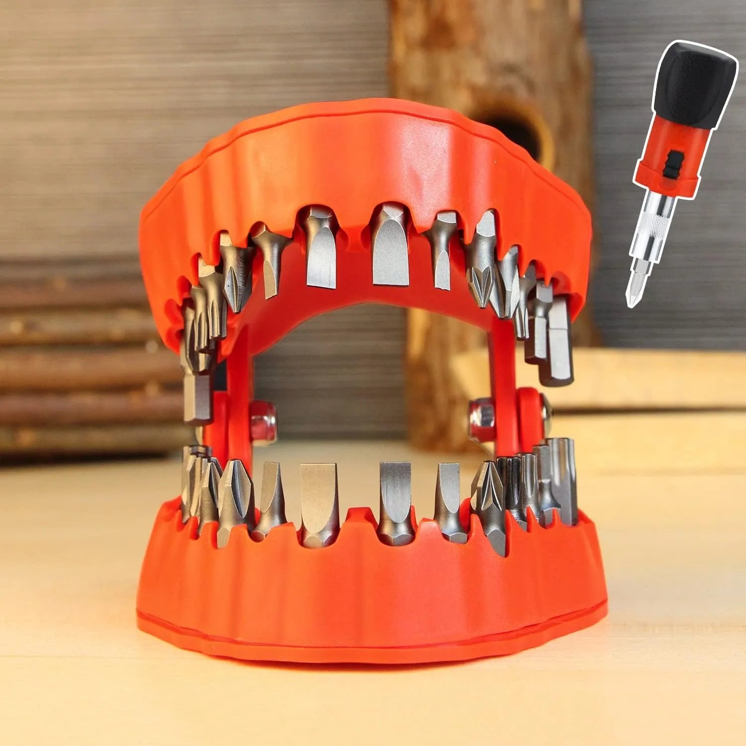 Red denture-shaped organizer holding screwdriver bits on a workbench