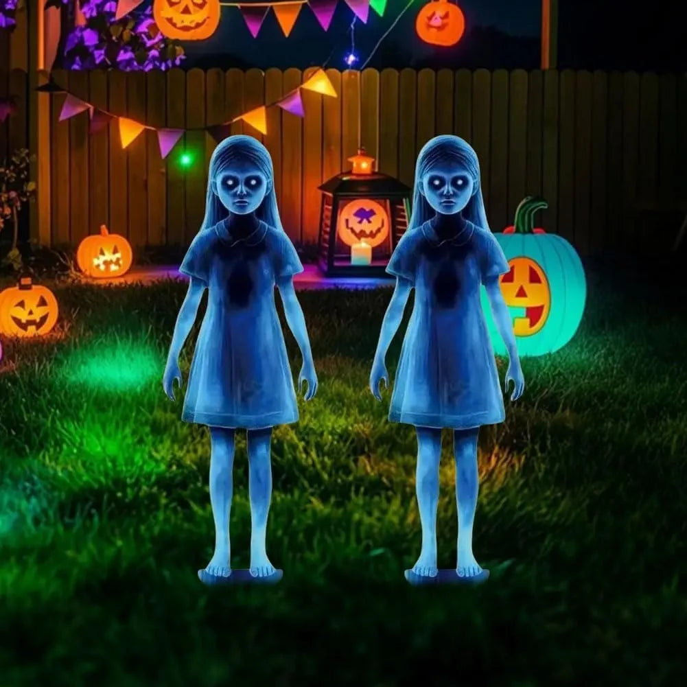 Two blue ghost-girl stakes in a colorful Halloween lawn display