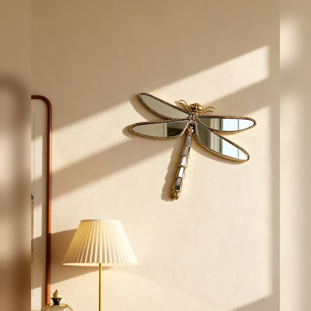 Dragonfly mirror displayed on a softly lit wall