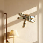 Dragonfly mirror displayed on a softly lit wall