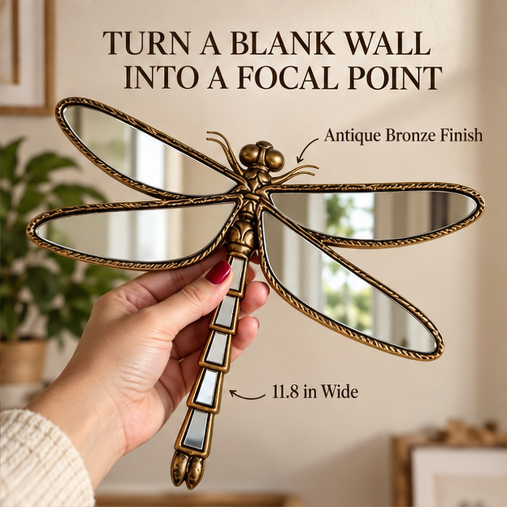 Hand holding an antique bronze dragonfly mirror near a wall