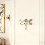 Dragonfly mirror displayed on a paneled wall
