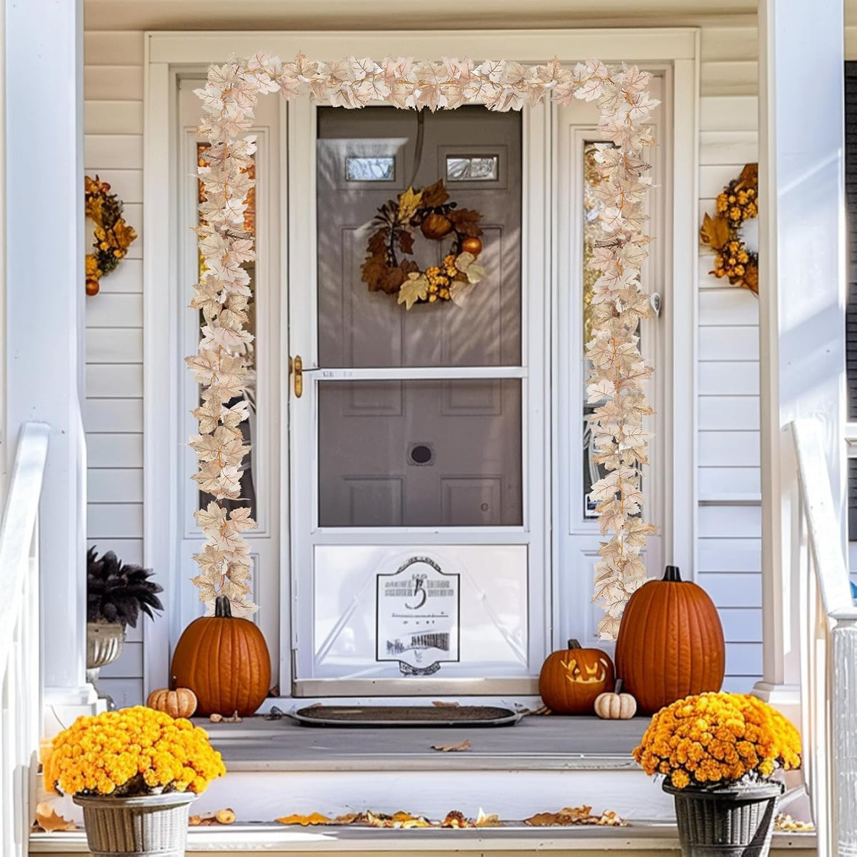 Ivory maple leaf garland arranged around a front doorway