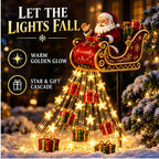 Close view of the red-and-gold Santa sleigh above the glowing cascade